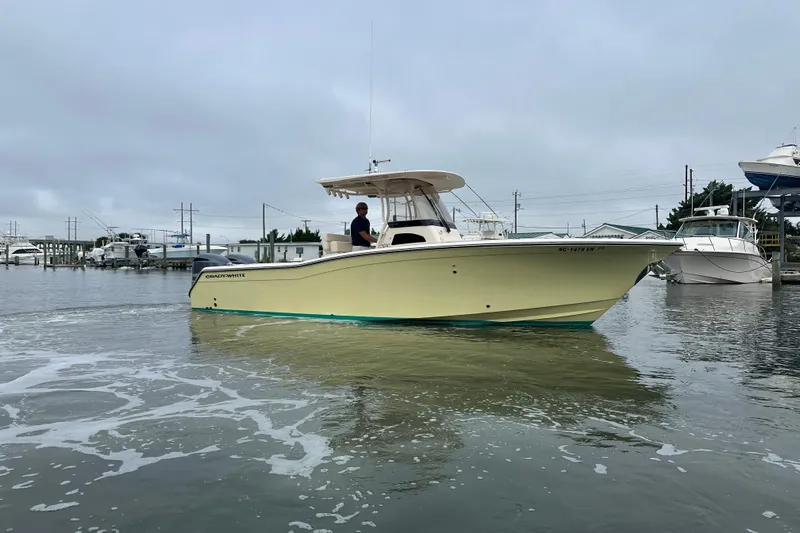  Yacht Photos Pics 2020 Grady-White Canyon 271 boat on calm water, overcast sky.