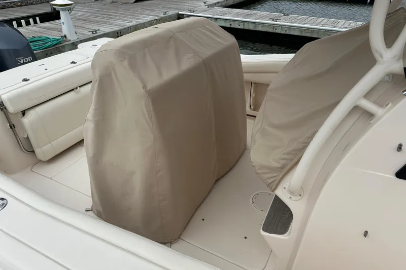  Yacht Photos Pics 2020 Grady-White Canyon 271 boat interior with covered seats at dock.