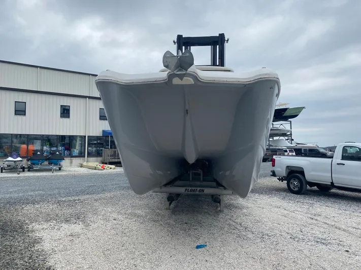  Yacht Photos Pics 2020 World Cat 320 CC boat on trailer, parked outside a building under cloudy skies.