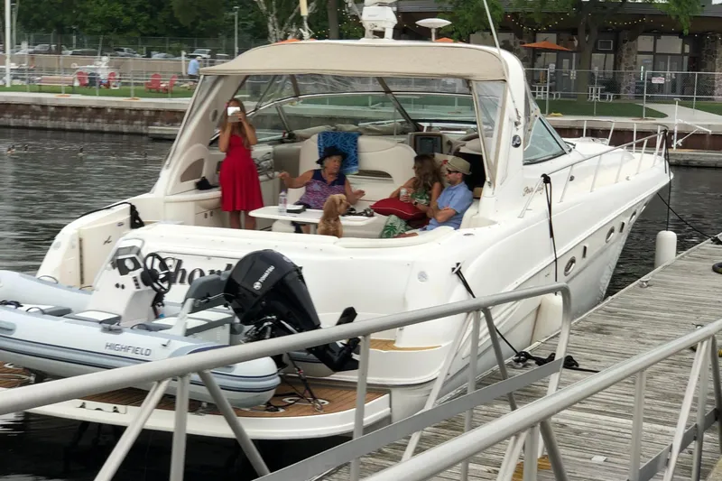 Kaboom Yacht Photos Pics 2000 Sea Ray 460 Sundancer yacht docked with people relaxing onboard.