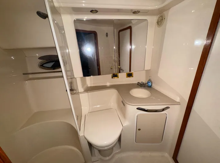 Kaboom Yacht Photos Pics Bathroom interior of 2000 Sea Ray 460 Sundancer yacht, featuring sink, toilet, and shower.