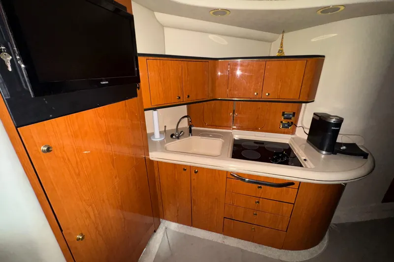 Kaboom Yacht Photos Pics 2000 Sea Ray 460 Sundancer yacht kitchen with wood cabinetry and modern appliances.