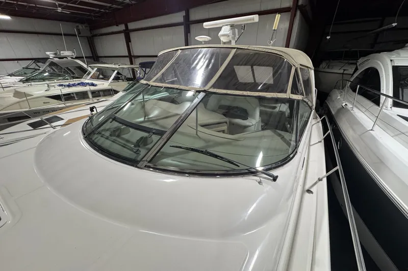 Kaboom Yacht Photos Pics Sea Ray 460 Sundancer 2000 yacht in storage, featuring sleek design and spacious cockpit.