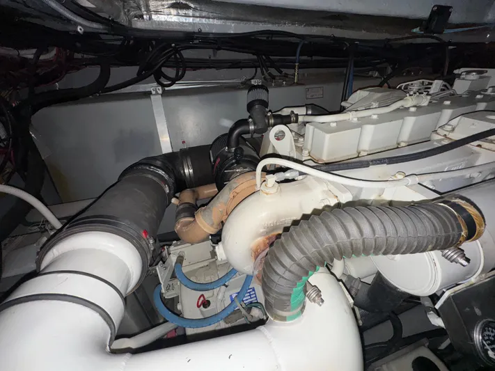 Kaboom Yacht Photos Pics Engine compartment of a 2000 Sea Ray 460 Sundancer boat, showcasing mechanical components.