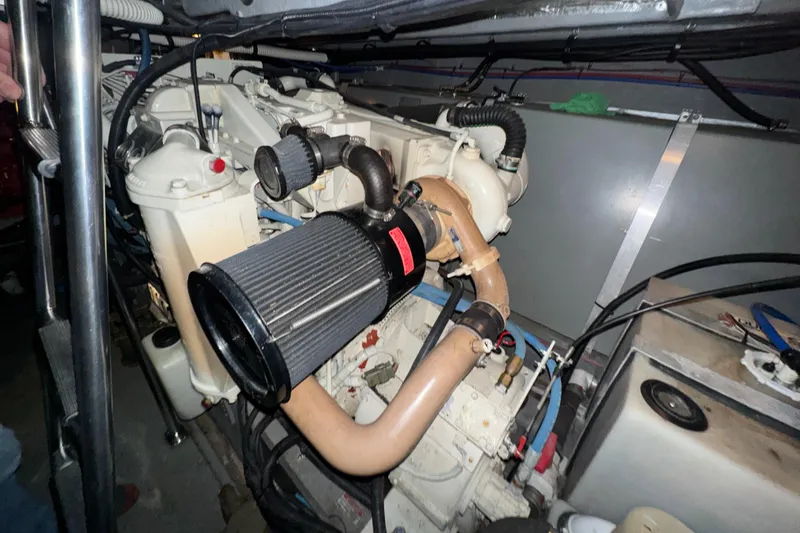 Kaboom Yacht Photos Pics Engine compartment of a 2000 Sea Ray 460 Sundancer boat, showcasing detailed components.