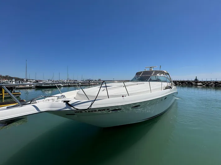 Kaboom Yacht Photos Pics 2000 Sea Ray 460 Sundancer yacht docked in a marina under clear blue skies.