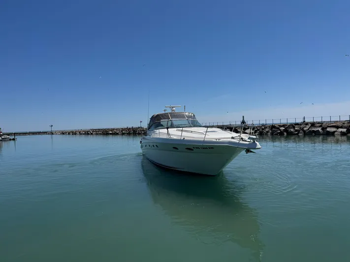Kaboom Yacht Photos Pics 2000 Sea Ray 460 Sundancer yacht on calm water under clear blue sky.