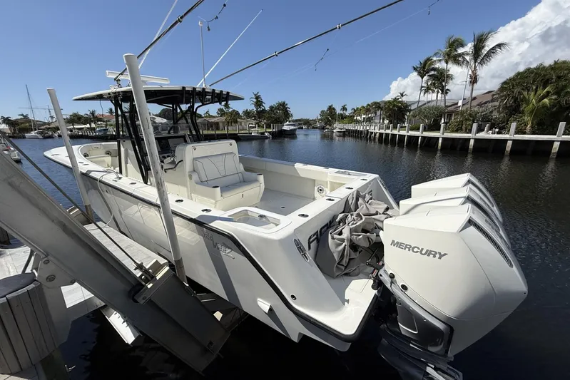 Seavee 37 Yacht Photos Pics 2021 SeaVee 37 boat with triple Mercury engines docked in a scenic canal.