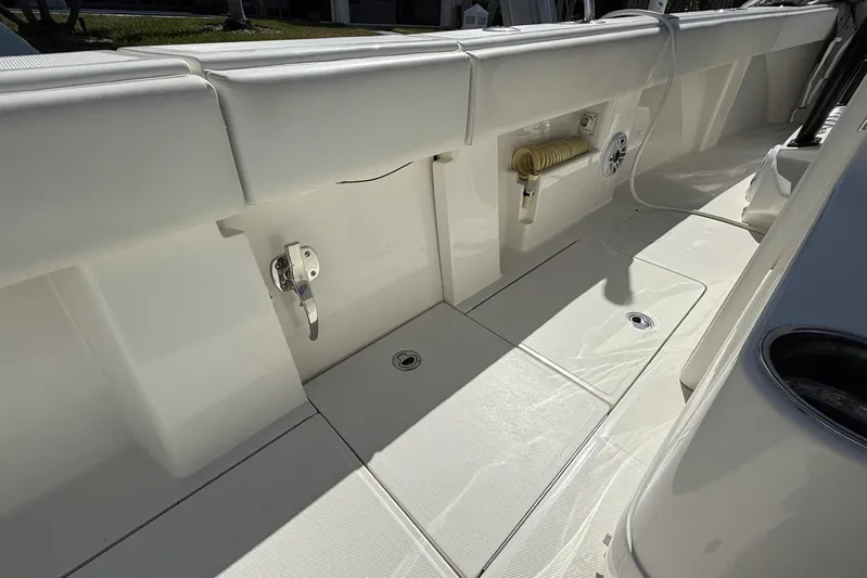 Seavee 37 Yacht Photos Pics 2021 SeaVee 37 boat deck with storage compartments and clean white finish.
