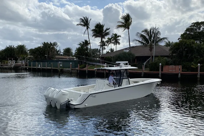 Seavee 37 Yacht Photos Pics 2021 SeaVee 37 boat cruising on a calm waterway with palm trees in the background.