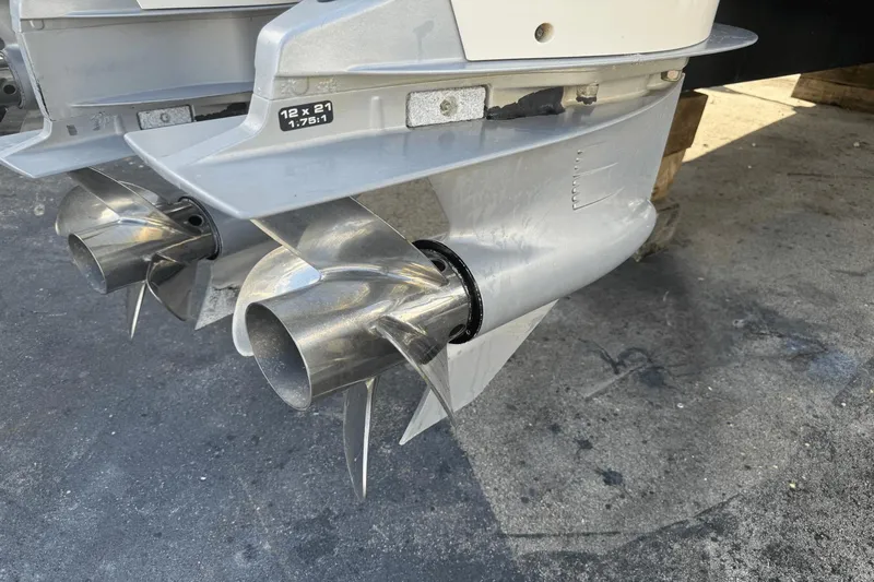  Yacht Photos Pics Close-up of 2019 Sea Ray 400 SLX OB boat propellers on a concrete surface.