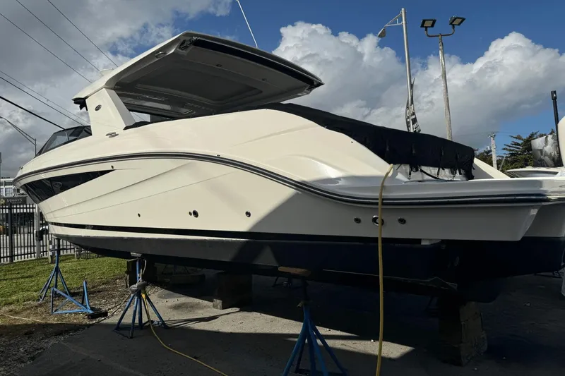  Yacht Photos Pics 2019 Sea Ray 400 SLX OB boat on stands, under a cloudy sky.