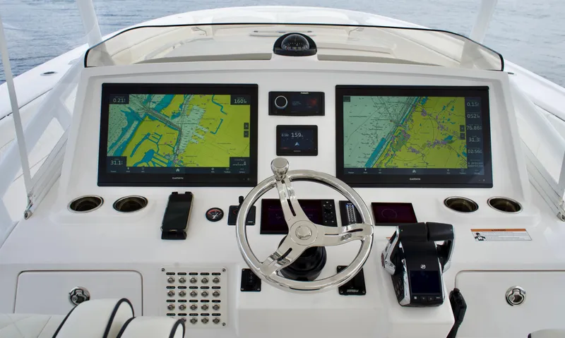  Yacht Photos Pics 2023 Intrepid 475 Panacea helm with dual navigation screens and modern controls.