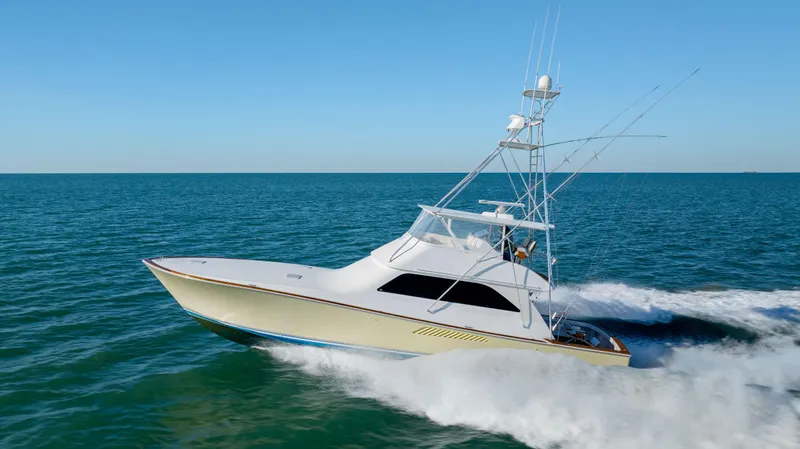 Sylva Lining Yacht Photos Pics 2001 Viking 61 Convertible yacht cruising on open sea under clear blue sky.