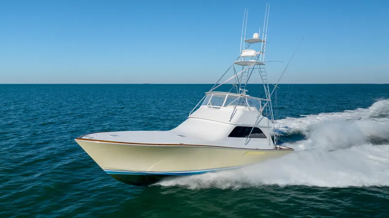 Sylva Lining Yacht Photos Pics 2001 Viking 61 Convertible yacht cruising on open sea under clear blue sky.