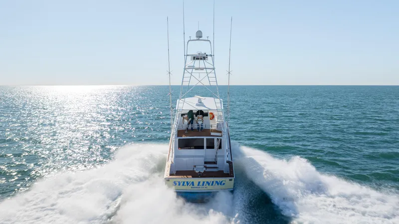 Sylva Lining Yacht Photos Pics 2001 Viking 61 Convertible yacht cruising on open sea, creating a wake.