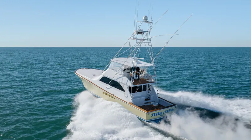 Sylva Lining Yacht Photos Pics 2001 Viking 61 Convertible yacht cruising on open sea.