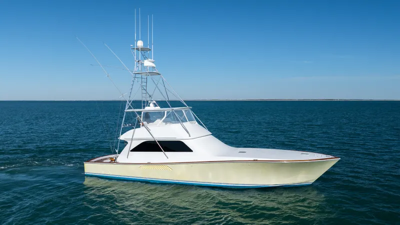 Sylva Lining Yacht Photos Pics 2001 Viking 61 Convertible yacht cruising on open water under clear blue skies.