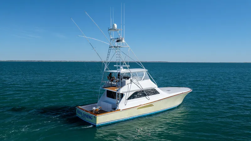 Sylva Lining Yacht Photos Pics 2001 Viking 61 Convertible yacht on open water under clear blue sky.