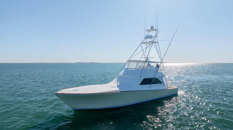 Sylva Lining Yacht Photos Pics 2001 Viking 61 Convertible yacht cruising on open water under clear skies.