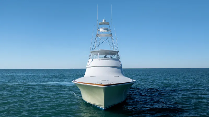 Sylva Lining Yacht Photos Pics Front view of a 2001 Viking 61 Convertible yacht cruising on open water.