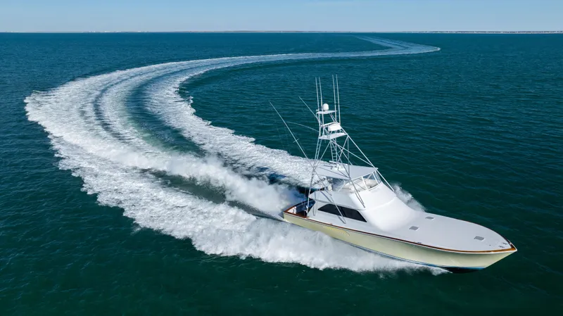 Sylva Lining Yacht Photos Pics 2001 Viking 61 Convertible yacht cruising swiftly on open water.