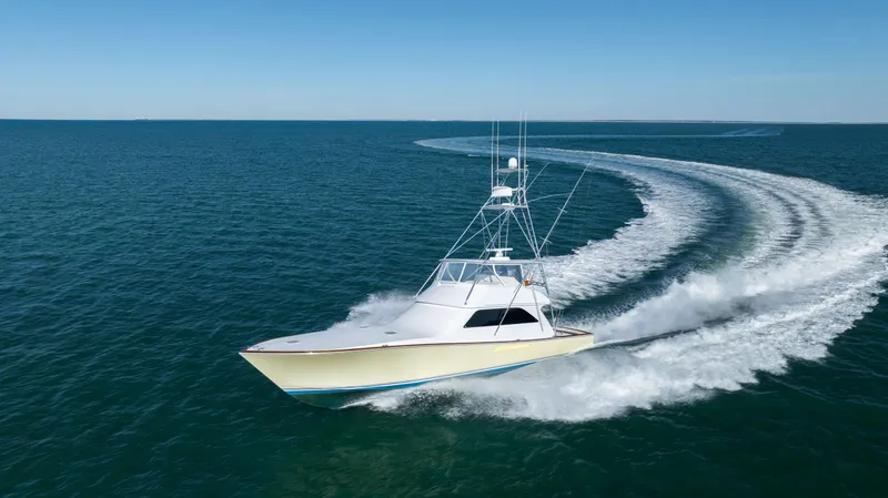 Sylva Lining Yacht Photos Pics 2001 Viking 61 Convertible yacht cruising swiftly on open water.