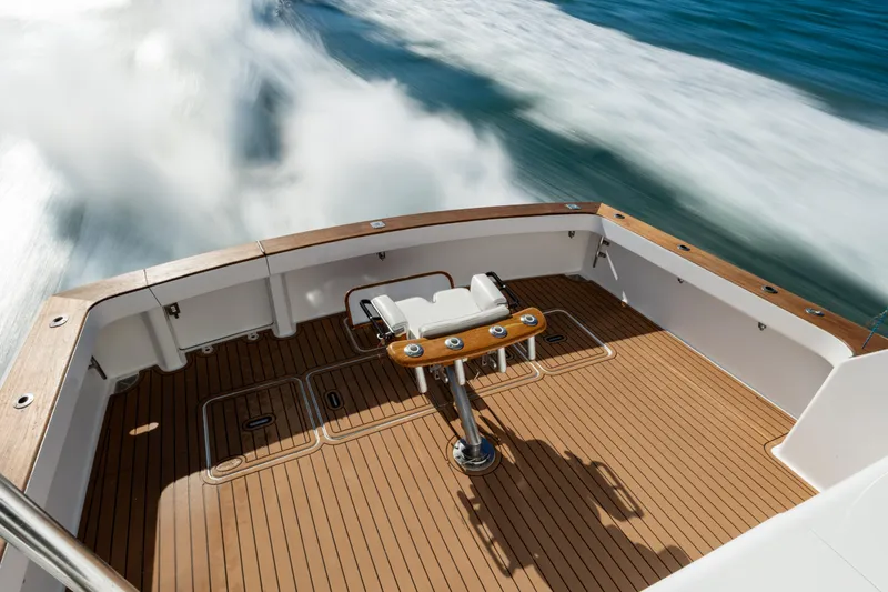 Sylva Lining Yacht Photos Pics 2001 Viking 61 Convertible yacht deck with teak flooring, cruising on open water.