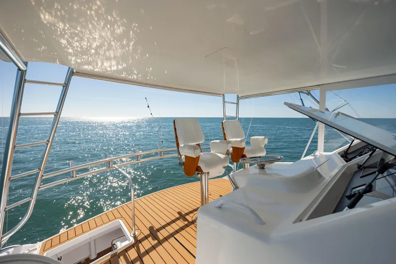 Sylva Lining Yacht Photos Pics 2001 Viking 61 Convertible yacht deck overlooking the ocean under clear blue skies.