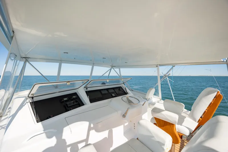 Sylva Lining Yacht Photos Pics 2001 Viking 61 Convertible yacht helm with ocean view, featuring white seating and navigation controls.