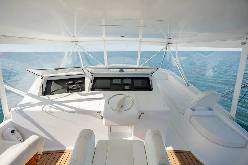 Sylva Lining Yacht Photos Pics 2001 Viking 61 Convertible yacht helm with ocean view, featuring modern controls and seating.