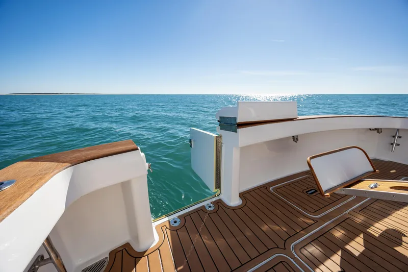 Sylva Lining Yacht Photos Pics Viking 61 Convertible 2001 yacht deck overlooking the ocean under clear blue sky.