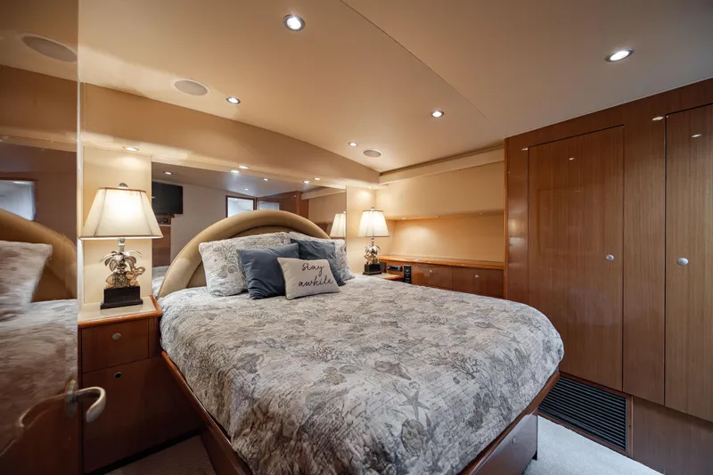 Sylva Lining Yacht Photos Pics Luxurious bedroom interior of 2001 Viking 61 Convertible yacht with elegant bedding and lighting.