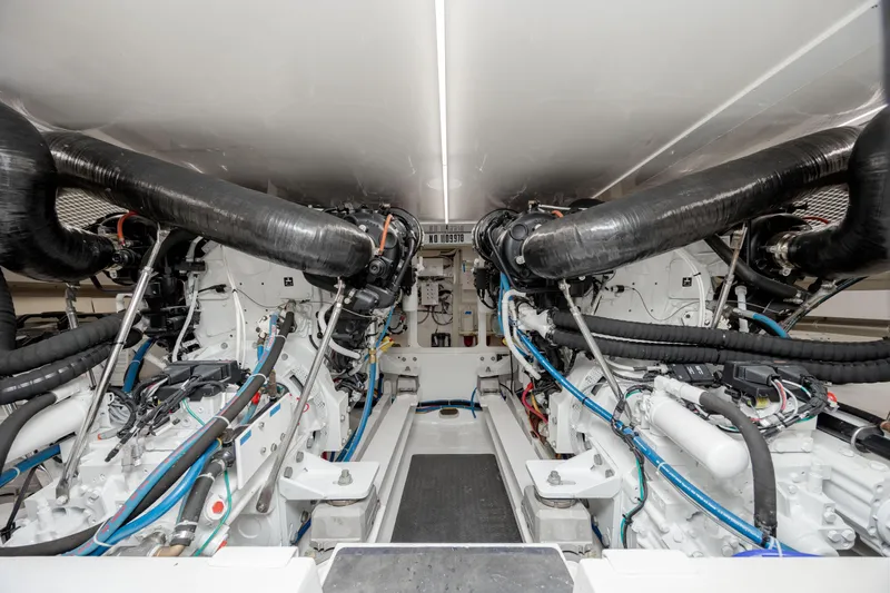 Sylva Lining Yacht Photos Pics Engine room of a 2001 Viking 61 Convertible yacht, showcasing dual engines and intricate piping.