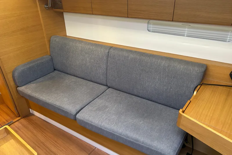 Xiomara Yacht Photos Pics 2019 X-Yachts X4&sup3; interior with gray sofa and wooden cabinetry.