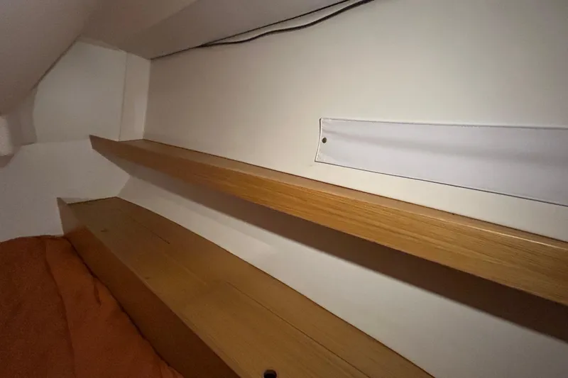 Xiomara Yacht Photos Pics Interior shelving of 2019 X-Yachts X4&sup3; sailboat, featuring wooden finish and minimalist design.