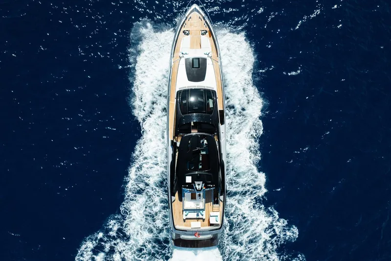  Yacht Photos Pics Aerial view of 2022 Riva 90' Argo yacht cruising on deep blue ocean.