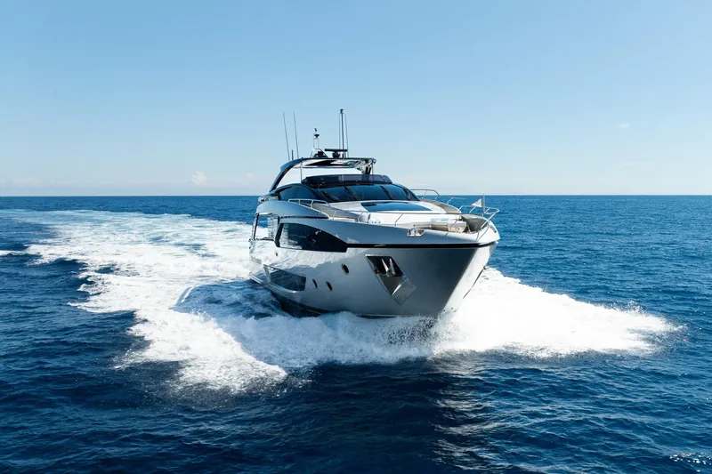  Yacht Photos Pics Luxury 2022 Riva 90' Argo yacht cruising on open sea under clear blue sky.