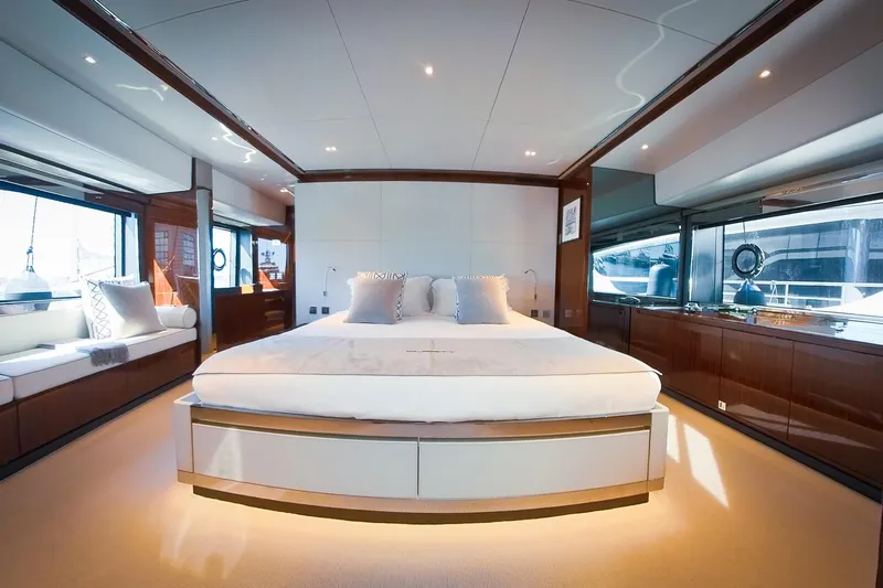  Yacht Photos Pics Luxurious bedroom interior of 2022 Riva 90' Argo yacht with elegant design and large windows.