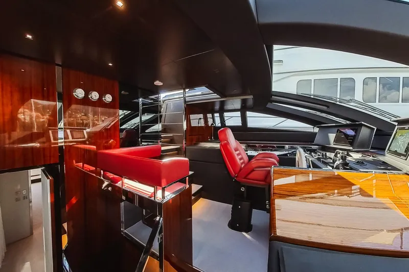  Yacht Photos Pics Luxurious interior of 2022 Riva 90' Argo yacht with sleek design and red seating.