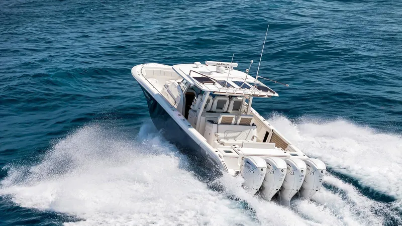 All Jack'd Up Yacht Photos Pics 2023 Pursuit S 428 Sport boat cruising on open ocean waters.