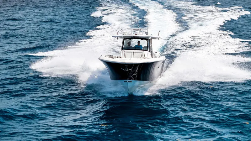 All Jack'd Up Yacht Photos Pics 2023 Pursuit S 428 Sport boat cruising on open blue water.