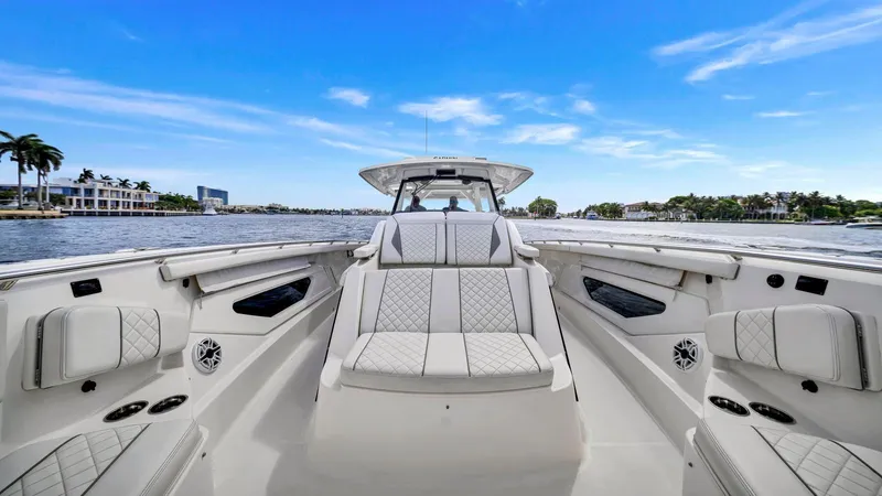 All Jack'd Up Yacht Photos Pics 2023 Pursuit S 428 Sport boat interior with luxurious seating on a sunny day.