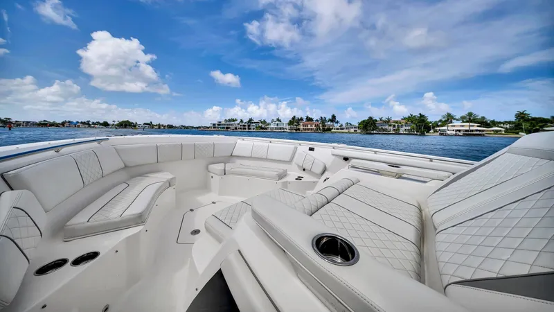All Jack'd Up Yacht Photos Pics Luxurious seating on 2023 Pursuit S 428 Sport boat, with scenic waterfront view.