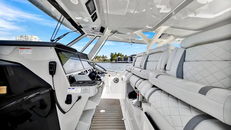 All Jack'd Up Yacht Photos Pics 2023 Pursuit S 428 Sport boat interior with luxurious seating and modern dashboard.