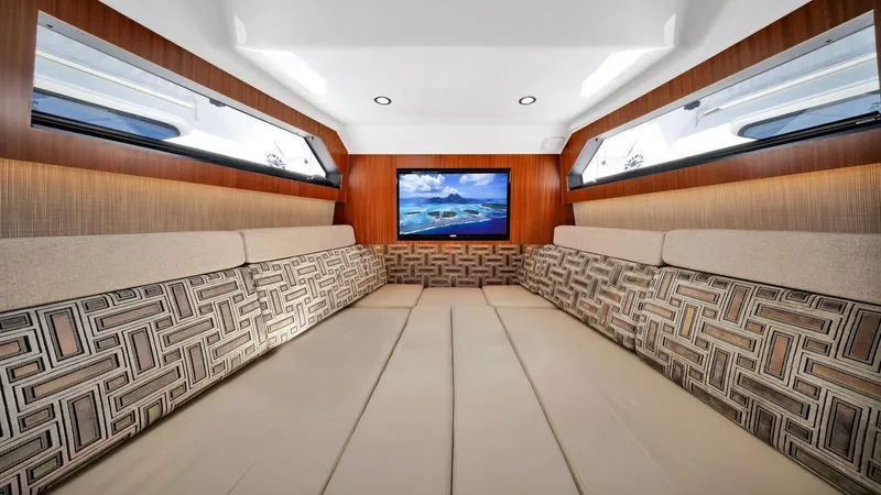 All Jack'd Up Yacht Photos Pics Luxurious interior of 2023 Pursuit S 428 Sport boat with plush seating and TV.