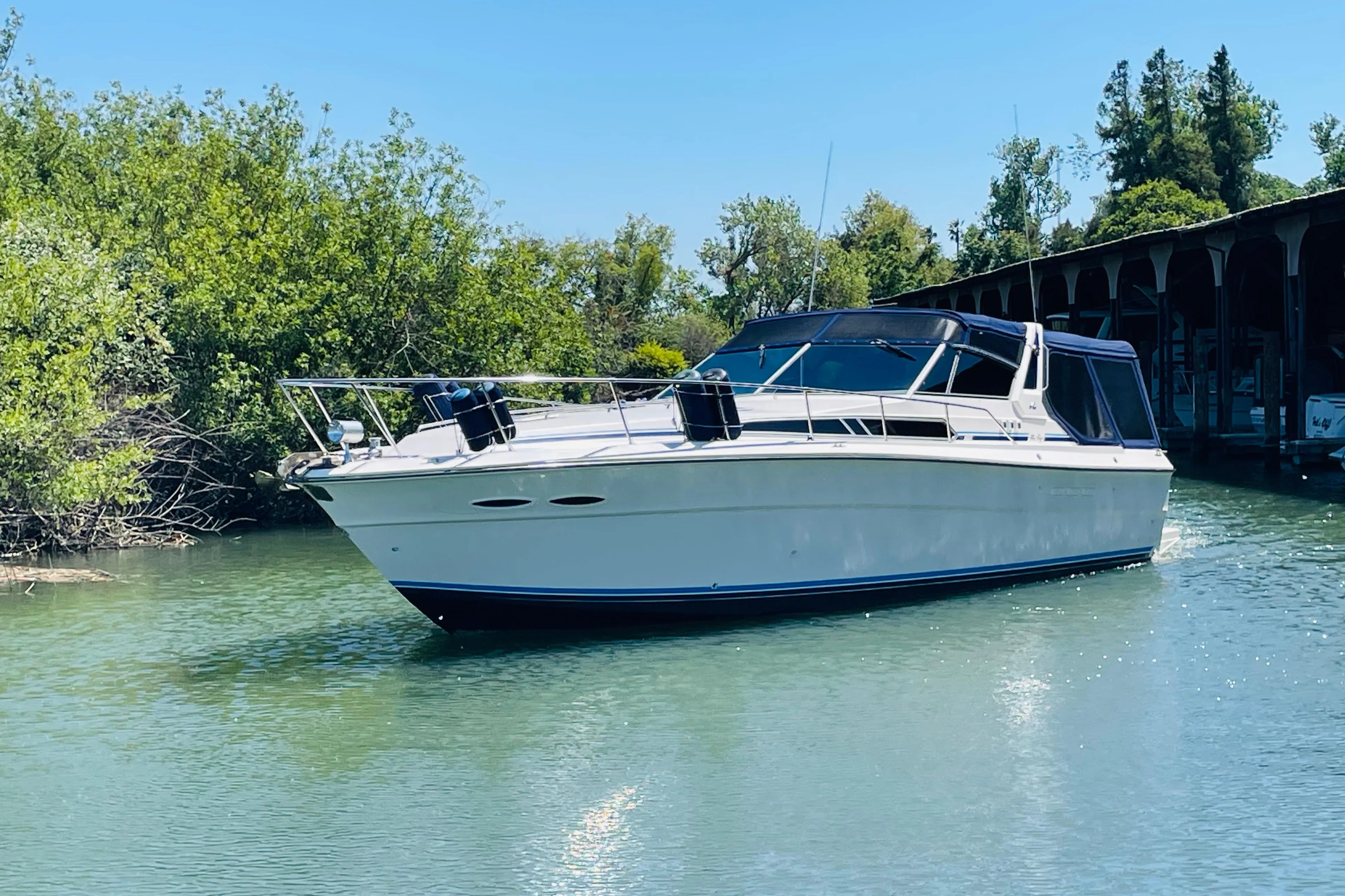 1989 Sea Ray 390 Express Cruiser on calm water.