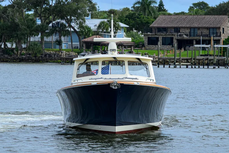 Gotcha Covered Yacht Photos Pics 2006 Hinckley Talaria 40 yacht cruising on a scenic waterfront.
