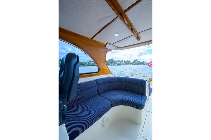 Gotcha Covered Yacht Photos Pics Interior of 2006 Hinckley Talaria 40 yacht with blue seating and wooden accents.