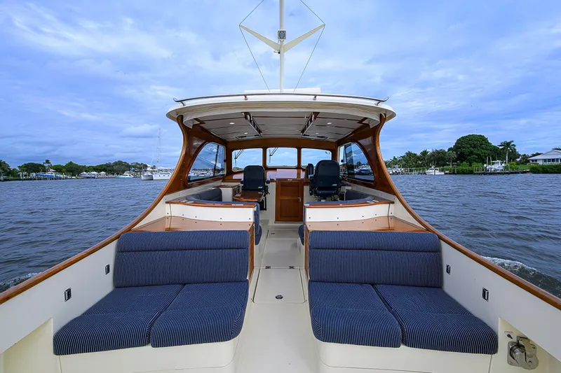 Gotcha Covered Yacht Photos Pics 2006 Hinckley Talaria 40 boat interior with blue seating, cruising on a calm river.